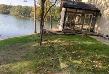 house near lake with leaves