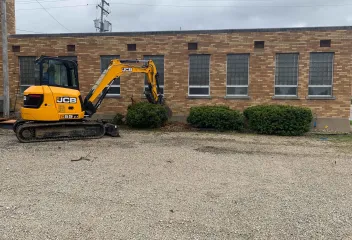 working equipment near bushes